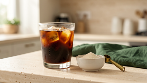 Iced coffee beside monk fruit sweetener on a cream stone counter